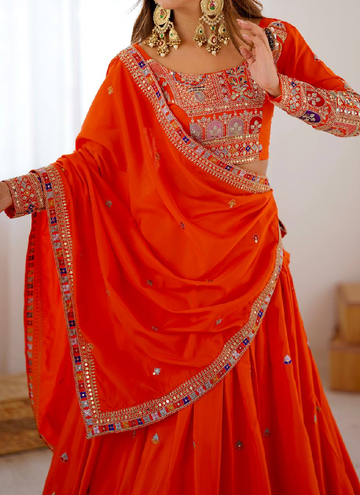 Amazing Party wear Orange Crepe Silk lehenga choli embellished with sequin coding work.